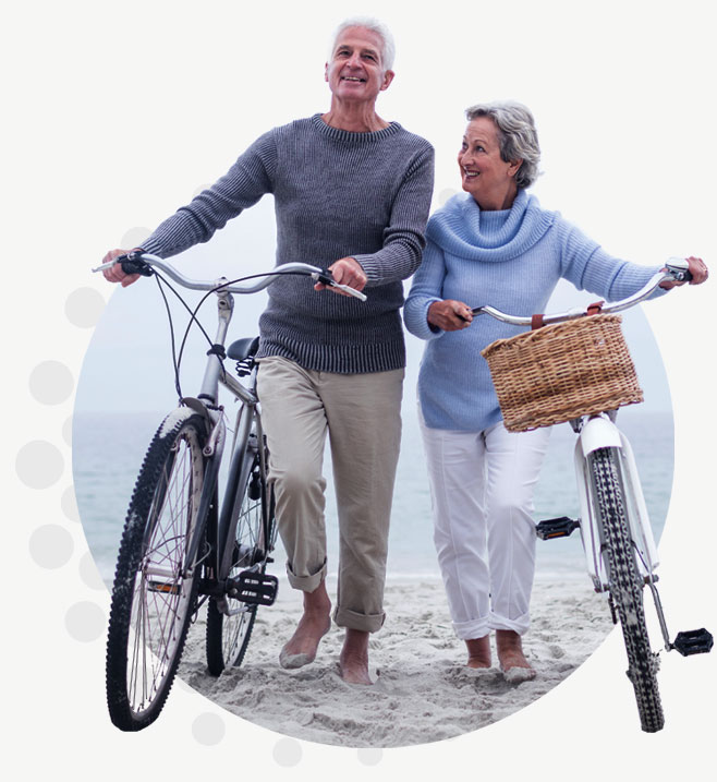 Elderly couple walking their bikes